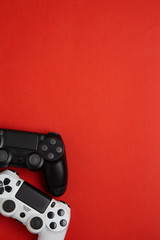 black and white  gamepads on a red. Gaming concept © solidmaks
