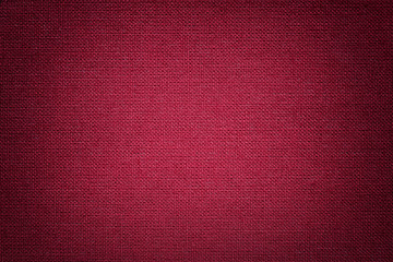 Fototapeta premium Dark red background from a textile material. Fabric with natural texture. Backdrop.