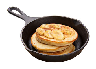 Pancakes in a cast iron skillet. On white background.