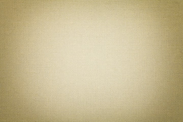 Light beige background from a textile material. Fabric with natural texture. Backdrop.