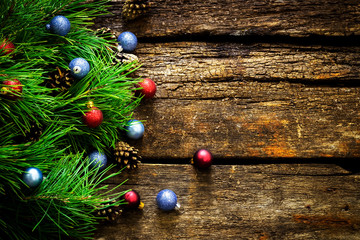 Vintage  Christmas holiday wooden planks rural background. Beautiful Empty Christmas Backdrop decorated with snow.  New Year Background.  Xmas background with pine branches,  toys and stars 