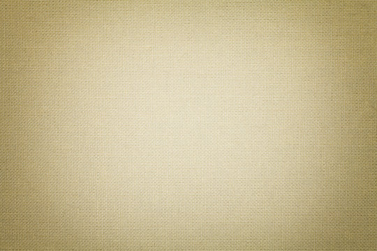 Light beige background from a textile material. Fabric with natural texture. Backdrop.