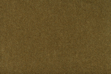Dark brown matt suede fabric closeup. Velvet texture of felt.