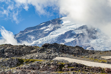 rugged mountain with glaciers in the fog and clouds in washington