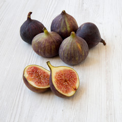Fresh figs on white wooden background, side view. Closeup. Copy space.