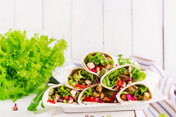 Chicken burrito. Healthy lunch.  Mexican street food fajita tortilla wraps with grilled  chicken fillet and fresh vegetables.