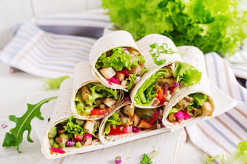 Chicken burrito. Healthy lunch.  Mexican street food fajita tortilla wraps with grilled  chicken fillet and fresh vegetables.