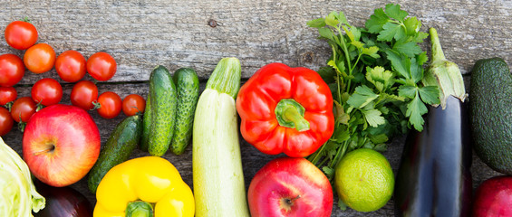 Set of colorful fruits and vegetables on dark wooden surface. Top view. From above. Flat lay.
