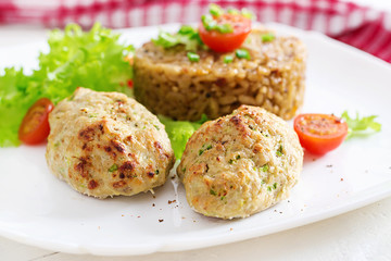 Homemade baked cutlets with rice on a table in a rustic style. Healthy food