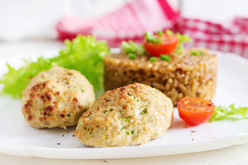Homemade baked cutlets with rice on a table in a rustic style. Healthy food