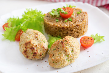 Homemade baked cutlets with rice on a table in a rustic style. Healthy food