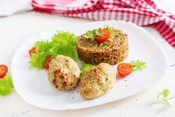 Homemade baked cutlets with rice on a table in a rustic style. Healthy food