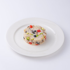 Rice with vegetables. Serving as in a restaurant. Isolated on white background.