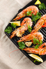Grilled shrimps with spice, garlic and lemon. Grilled seafood. Langoustines.