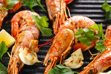 Grilled shrimps with spice, garlic and lemon. Grilled seafood. Langoustines.