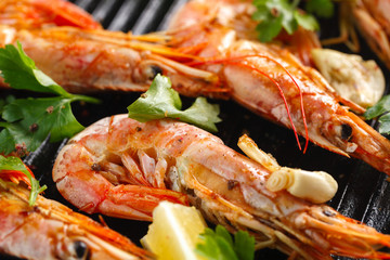 Grilled shrimps with spice, garlic and lemon. Grilled seafood. Langoustines.