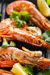 Grilled shrimps with spice, garlic and lemon. Grilled seafood. Langoustines.