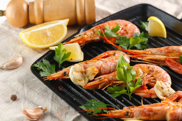 Grilled shrimps with spice, garlic and lemon. Grilled seafood. Langoustines.