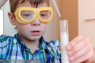 Experiments on chemistry at home. Chemical reaction with the release of gas in the test tube in the...