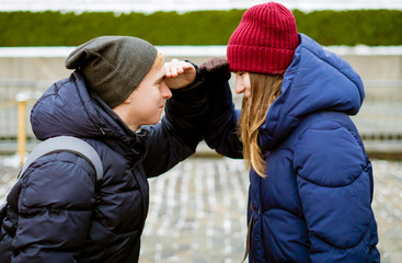 young couple searching each other and looking far away outdoor on a winter day f