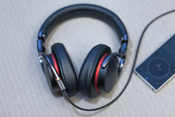 modern headphones near mp3 player