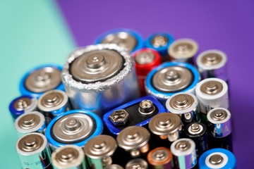Many different types used or new battery, rechargeable accumulator, alkaline batteries on color...