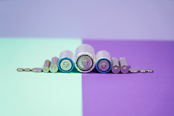 Many different types used or new battery, rechargeable accumulator, alkaline batteries on color...