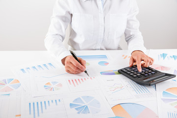 Business woman pointing at graph document close-up.