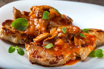 Fried pork chops with vegetables sauce and herbs