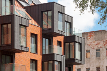 Contemporary Residential Building Exterior in the Daylight with modern balcony and brick facade