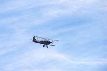 Fototapeta na wymiar a green old plane flying in an air show