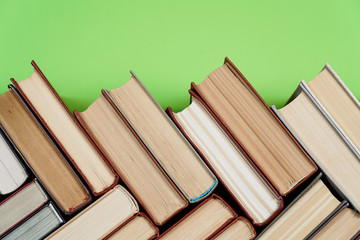 Many Books Piles. Hardback books on wooden table. Back to school.