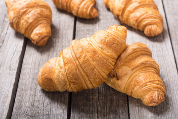 Croissants on wooden background