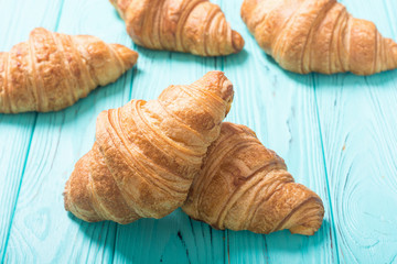 Croissants on wooden background