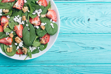 Strawberry salad with spinach , cheese and walnut . Healthy food