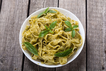 Pasta tagliatelle with green sauce pesto . Italian food background