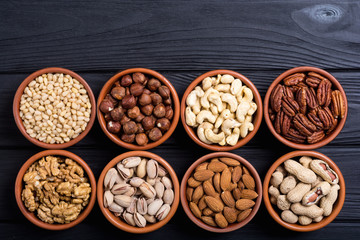 Mix of nuts : Pistachios, almonds , walnuts , pine nut , hazelnuts and cashew . Snack in bowl backgrond