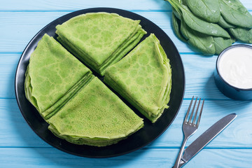 Homemade green pancakes with spinach . healthy crapes