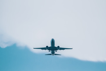Plane Flying on Blue Cloudy Sky