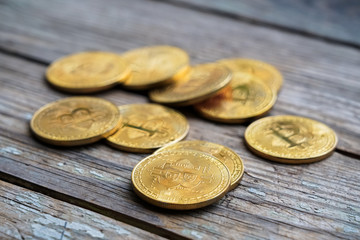 Gold Bitcoin money on wooden table. Electronic crypto currency