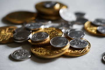 Macro shot detail of golden and silver color coin stacks on dark background with copy space for text. Business and finance growth, saving money, investment and interest concept.