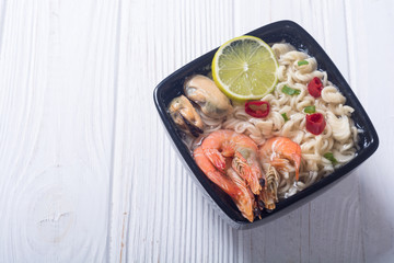 Instant noodles soup with shrimps and mssels . Asian food