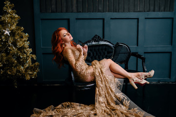 young woman in luxurious dress sitting on sofa