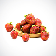 Sweet strawberry in wooden plate on a white background.