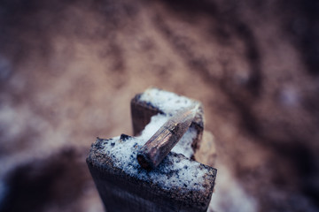 Bullet After Being Shot on The Snowy Sand Background
