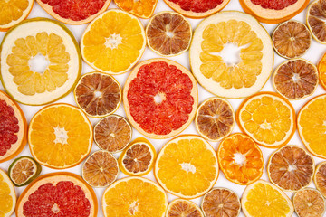 Dried slices of various citrus fruits on white background