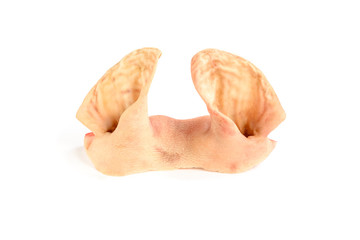 Raw pig ears isolated on white background.