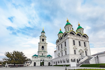 Fototapeta na wymiar Assumption Cathedral of the Blessed Virgin Mary, snow white christian church, in cold summer weather under thick clouds or veil. Historical and architectural complex Astrakhan Kremlin, Russia.