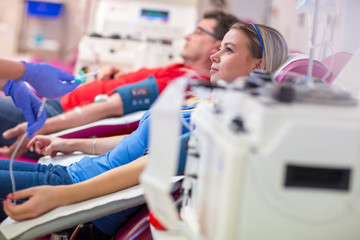 Young woman giving blood in a modern hospital