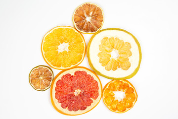 Dried slices of various citrus fruits on white background